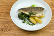 Pan Seared Sea Bass with Confit Potatoes, Buttered Asparagus and Chimichurri